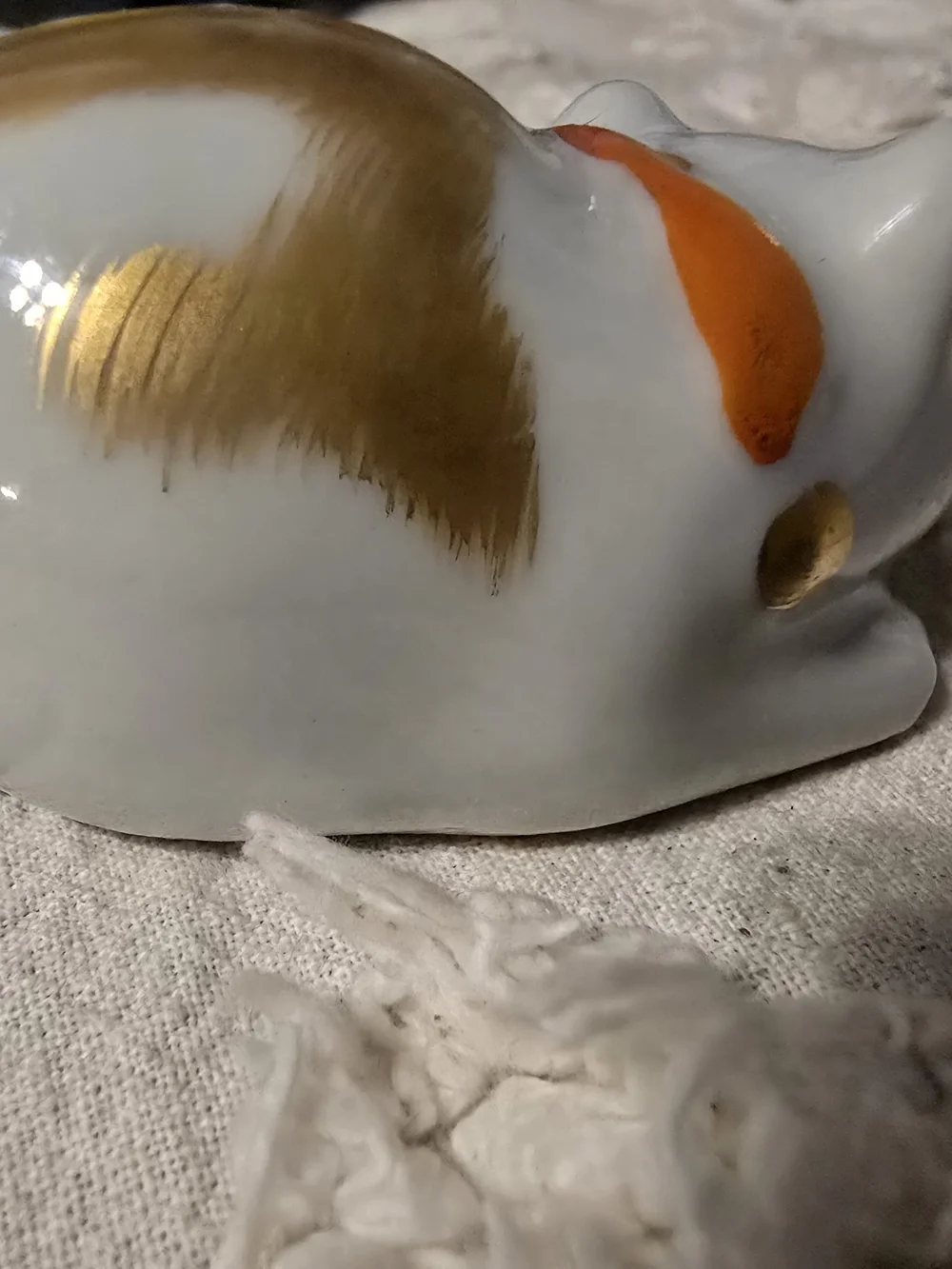 White Ceramic Sleeping Cat Figurine with Gold Accents and Orange Collar